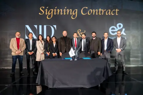 Signing ceremony with the NJD and e& business backdrop
