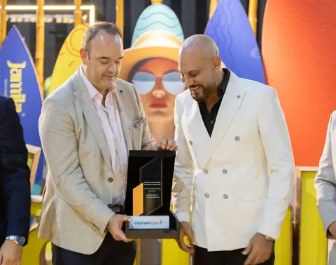 Girgis Youssef receiving an award plaque