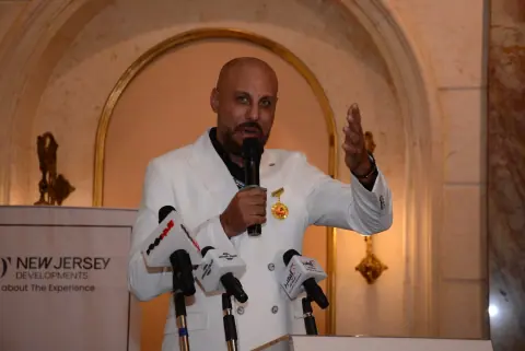 Girgis Youssef at a press conference podium